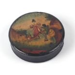 An 18th century painted papier-mâché snuff box of circular form, the top decorated with two