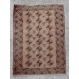 A Persian carpet with repeating geometric patterns on a brown ground, 63 by 50cms; together with