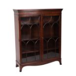 A 19th cntury style mahogany bookcase, the pair of astragal glazed doors enclosing a shelved