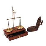 A boxed set of balance scales; together with a cased set of graduated brass weights in a box in