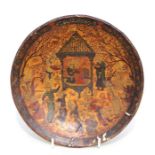 A Persian lacquered papier-mâché footed shallow dish decorated with figures in a court scene and
