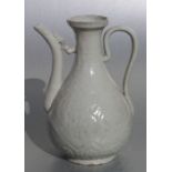 A Chinese pale celadon glaze wine ewer with moulded decoration, 24cms high.