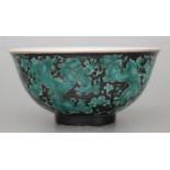 A Chinese famille noir footed bowl decorated with butterflies, fruit and foliage, six character blue