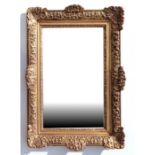 A Victorian style gilt gesso wall mirror, 75cms wide.