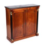 A late 19th century Egyptian Revival walnut side cabinet the twin panelled doors flanked by ebonised