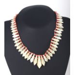 A mother of pearl and pink coral style bead necklace.