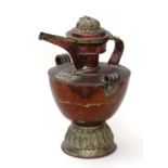 A Tibetan copper and brass butter tea pot, 41cms high.