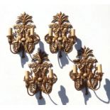 A set of four gilt metal rococo style twin-branch wall lights, 37cms high (4).