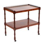 A mahogany two-tier trolley with tree quarter brass gallery, 69cms wide.Condition ReportThe three