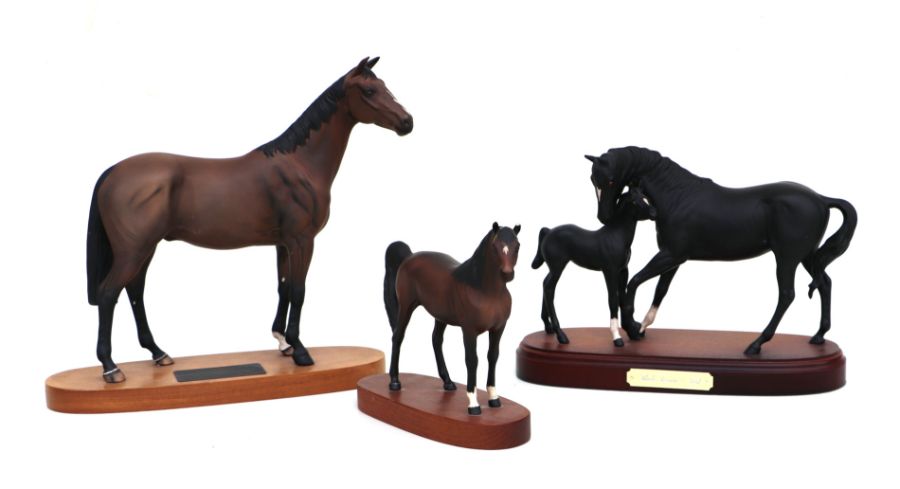 A Royal Doulton group 'Black Beauty and Foal', mounted on a wooden plinth, 30cms wide; together with