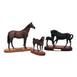 A Royal Doulton group 'Black Beauty and Foal', mounted on a wooden plinth, 30cms wide; together with