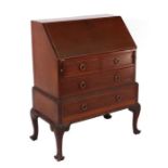 An Edwardian mahogany bureau, the fall-flap enclosing a fitted interior above two short and two