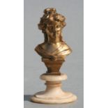 A gilt metal bust depicting a young lady mounted on a marble socle, 14cms high.
