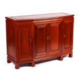 A Chinese hardwood sideboard with four cupboard doors, 112cms wide.