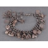 A silver charm bracelet and loose charms.