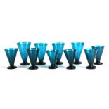 A group of ten turquoise soda glass goblets with snapped off pontil marks, the largest 14cms high,