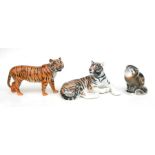 A Beswick figure of a standing tiger, 28cms long; together with a Lomonosov figure of a recumbent