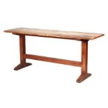 A Heals Arts & Crafts oak refectory or serving table, the rectangular top on trestle end supports