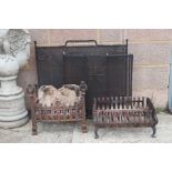 A wrought iron fire basket, 52cms wide; together with another similar, 46cms wide; and two spark