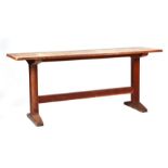 A Heals Arts & Crafts oak refectory or serving table, the rectangular top on trestle end supports