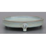 A Chinese celadon glaze tripod brush washer, 14cms diameter.