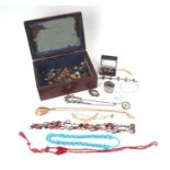 A quantity of costume jewellery to include necklaces and brooches.