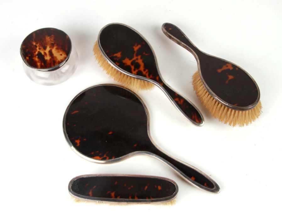 An Edwardian five-piece silver and tortoiseshell dressing table set, Sheffield and various date