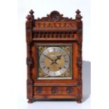 An Edwardian mantle clock, the rectangular brass dial with silvered chapter ring and Roman and