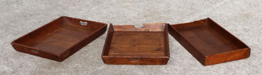 Three WWI waxed pine rectangular trays, stamped '1917', each 63cms wide (3).