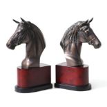 A pair of patinated bronzed horse bust study bookends, 30cms high.