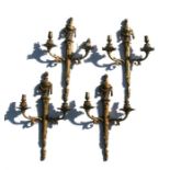 A set of four Adams style gilt metal twin-arm wall lights, 42cms high (4).