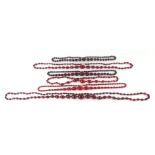 A group of six cherry amber Bakelite faceted graduated bead necklaces, one with a 9ct gold clasp,