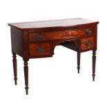 A 19th century bowfronted sideboard with single frieze drawer above two short drawers, on reeded