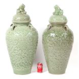 A large pair of Asian celadon glaze temple vases and covers, each with four applied loop handles and