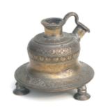 An Islamic hookah pipe base with tinned brass decoration, on tripod legs, 13cms wide.