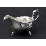A George III style silver sauce boat with shell capped hoof feet, Birmingham 1919, 176g.