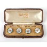 A boxed set of 9ct gold mother of pearl and enamel buttons.