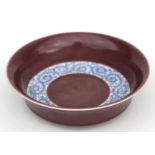 A Chinese shallow bowl decorated with scrolling blue & white foliage, on a aubergine ground, six