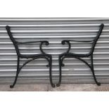 A pair of painted cast iron bench ends.
