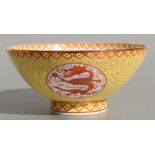 A Chinese Republic style footed bowl decorated with dragons within roundels, on a yellow ground with