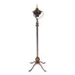 An Arts & Crafts steel oil standard lamp converted to electricity, 138cms high.