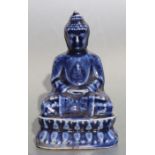 A Chinese monochrome seated figure of Buddha, 14cms high.