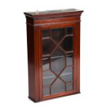 An Edwardian inlaid mahogany wall mounted display cabinet, the astragal glazed door enclosing a