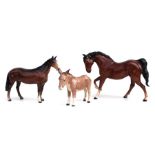 A Beswick donkey; together with two Beswick horses (3).