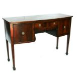 A 19th century style mahogany bow fronted sideboard with central frieze drawer flanked by cupboards,