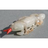 A Chinese jade / hardstone carving in the form of a fish swallowing another fish, 7.5cms long.