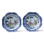 A pair of Chinese famille rose bowls decorated with a robed lady on a terrace with a young boy