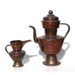 A large Tibetan copper and brass butter tea pot, 44cms high; together with a copper and brass jug,
