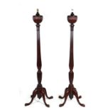 A pair of early 20th century George III style mahogany standard lamps with tapering fluted and urn