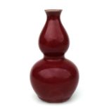 A Chinese sang de boeuf double gourd vase, 17cms high.